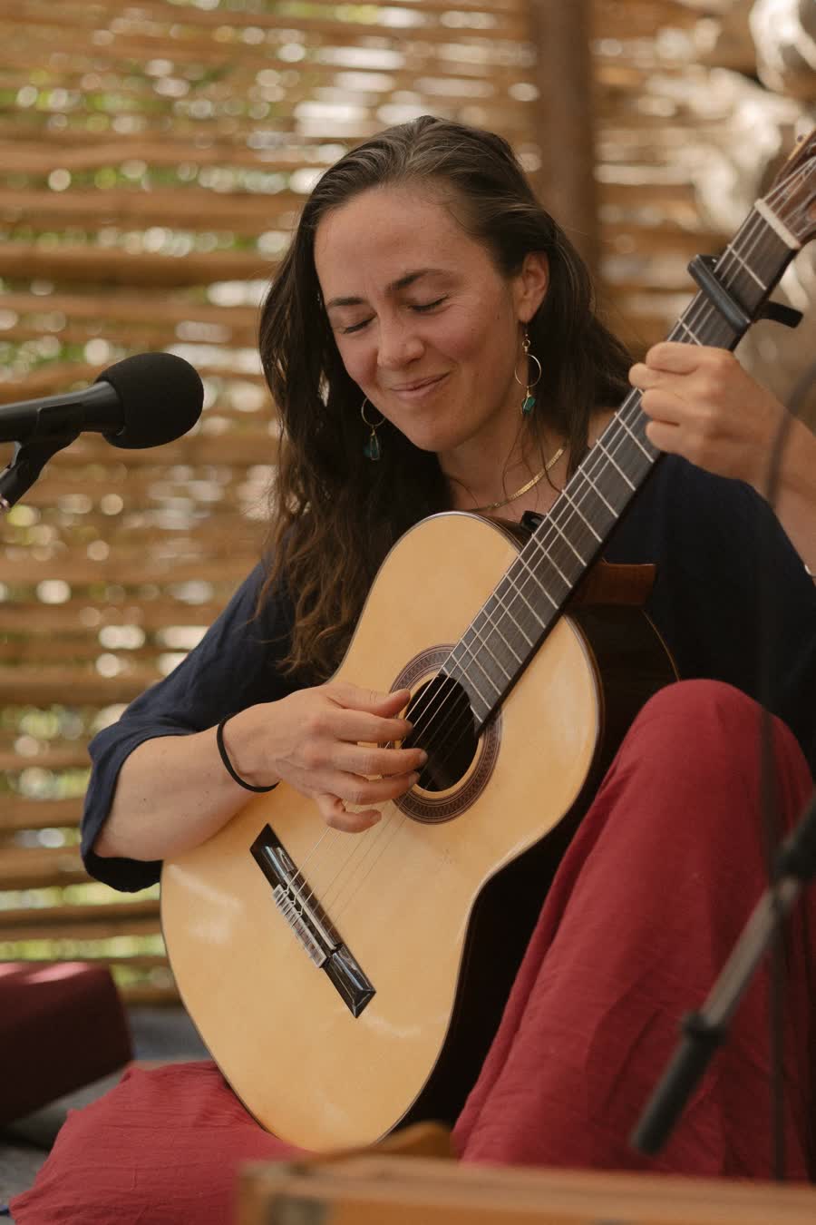 Helen Pickles playing guitar and singing